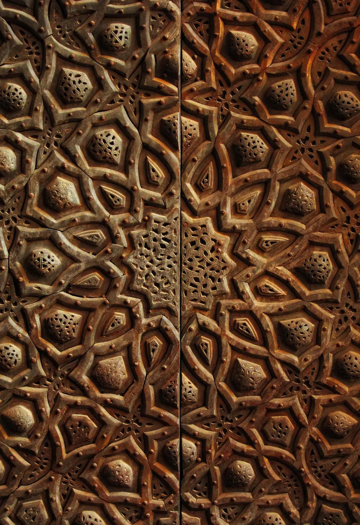 Geometric wooden door pattern at the Mosque of Sultan Hassan in Cairo